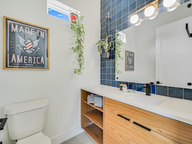 bathroom with vanity, a healthy amount of sunlight, and toilet