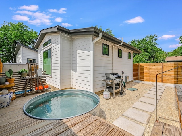 rear view of house featuring a deck