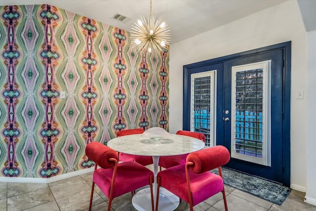 dining area featuring light tile patterned floors, french doors, and a chandelier