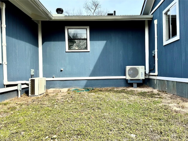 view of property exterior with ac unit and a yard