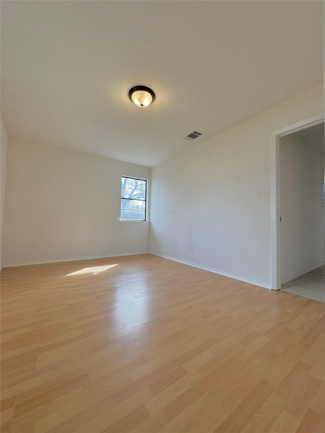 spare room featuring light hardwood / wood-style floors