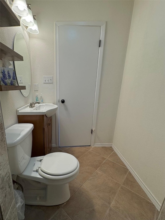 bathroom with tile patterned floors, toilet, and vanity