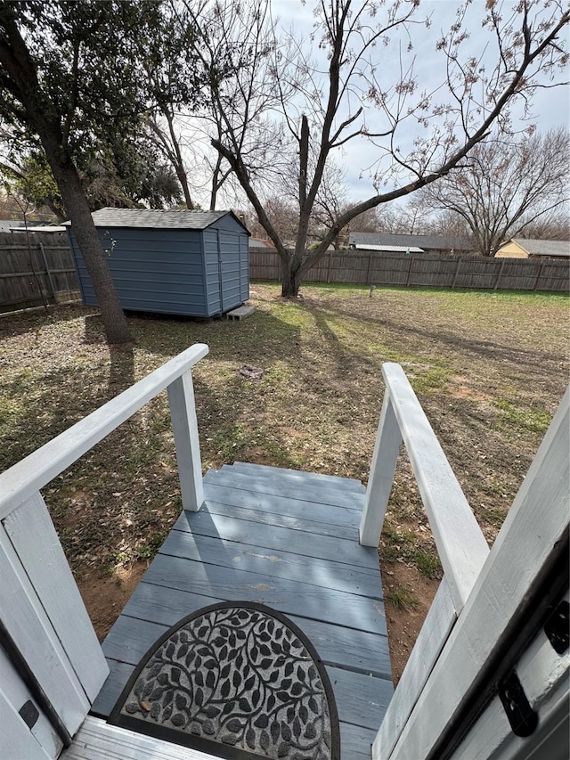 view of yard featuring a storage shed and a wooden deck