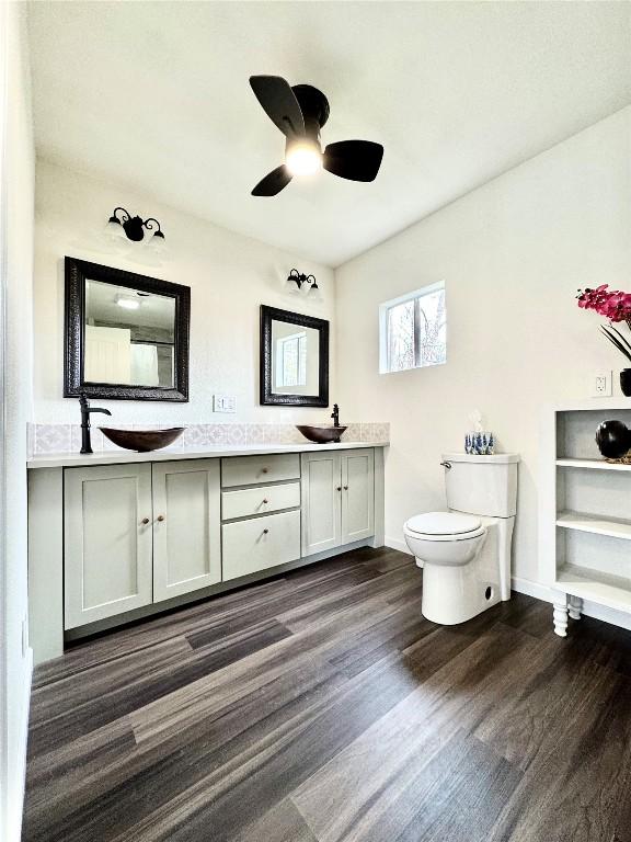 bathroom featuring vanity, hardwood / wood-style floors, toilet, and ceiling fan