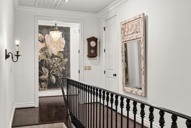 hallway with wood-type flooring and ornamental molding