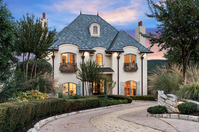 french country style house featuring a balcony