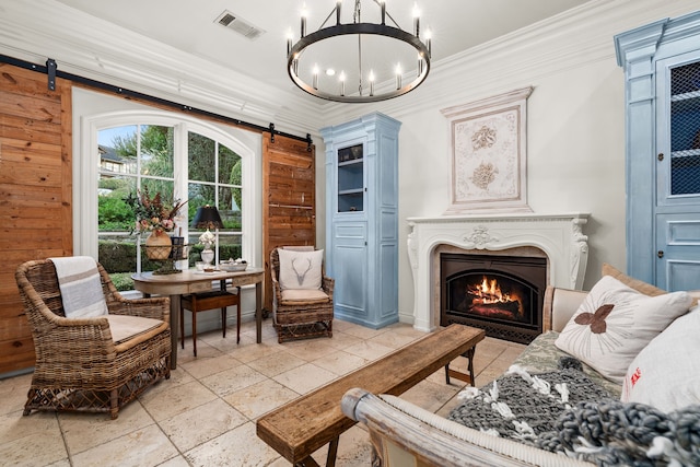 sitting room with crown molding, wood walls, and a barn door