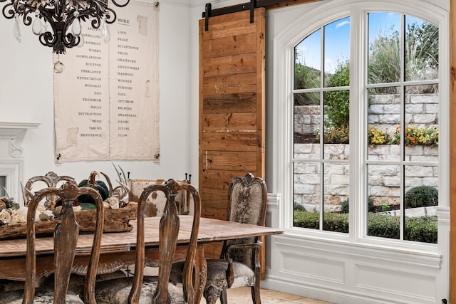 dining room with a wealth of natural light, a notable chandelier, and a barn door