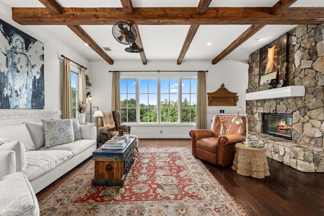 living room featuring dark wood-type flooring and a stone fireplace