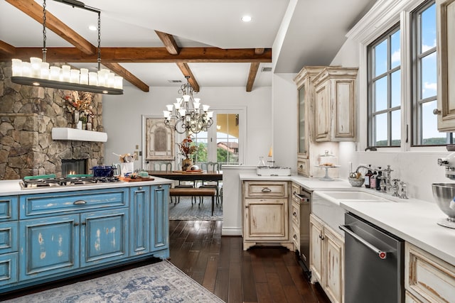 kitchen with an inviting chandelier, appliances with stainless steel finishes, dark hardwood / wood-style flooring, and hanging light fixtures