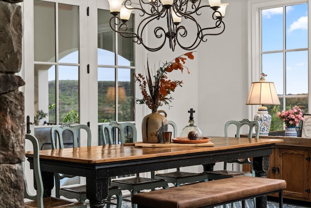 dining area featuring a wealth of natural light and a chandelier