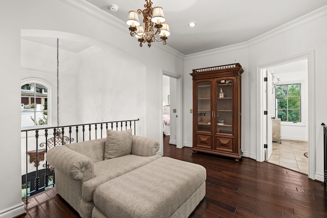 interior space featuring ornamental molding, a chandelier, and hardwood / wood-style flooring