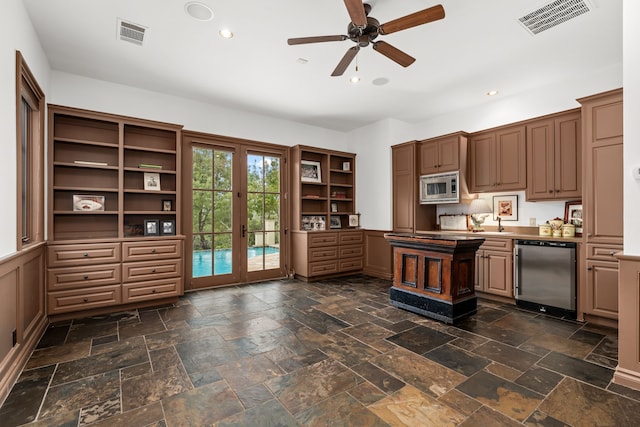 kitchen with ceiling fan, french doors, appliances with stainless steel finishes, and sink