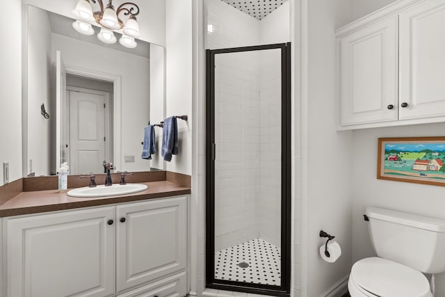 bathroom with an enclosed shower, vanity, and toilet