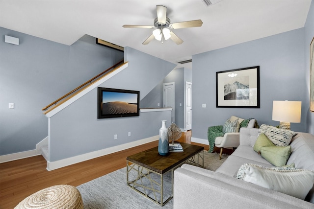 living room with ceiling fan and hardwood / wood-style flooring