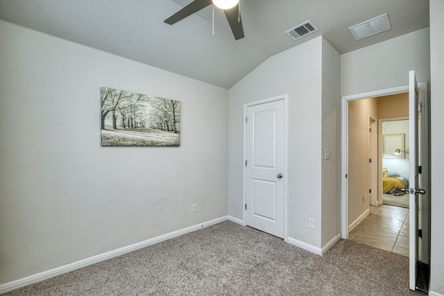 unfurnished bedroom with vaulted ceiling, ceiling fan, and carpet floors