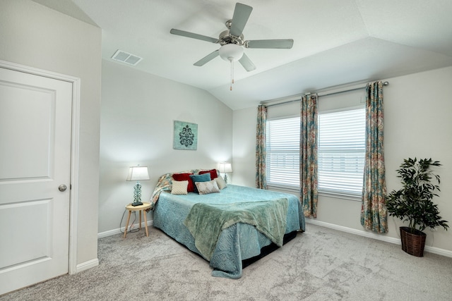 carpeted bedroom with ceiling fan and vaulted ceiling