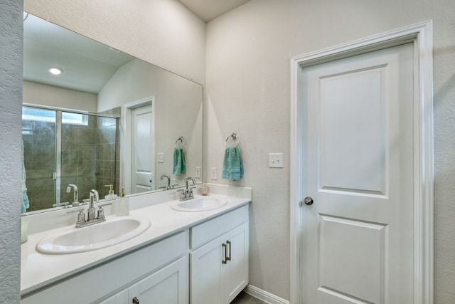 bathroom with vaulted ceiling, a shower with shower door, and vanity