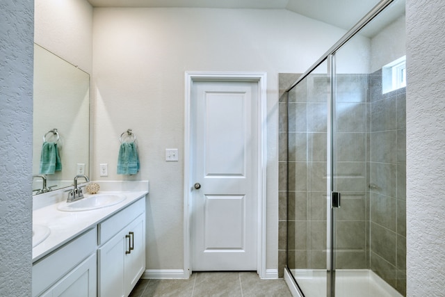 bathroom featuring a shower with door, vanity, and tile patterned flooring