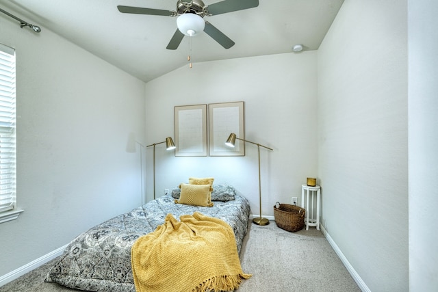 bedroom with vaulted ceiling, ceiling fan, and carpet flooring