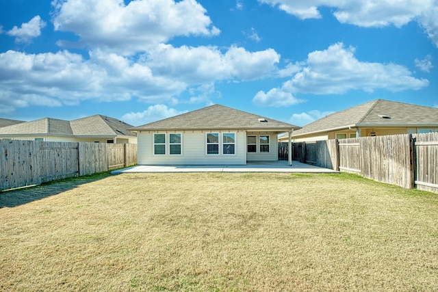 rear view of house with a lawn and a patio area