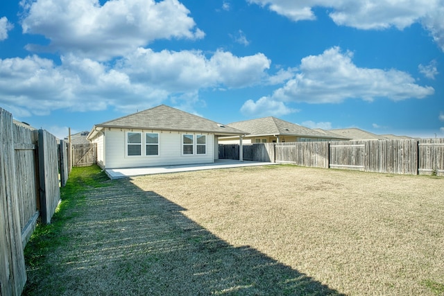 back of house featuring a yard and a patio