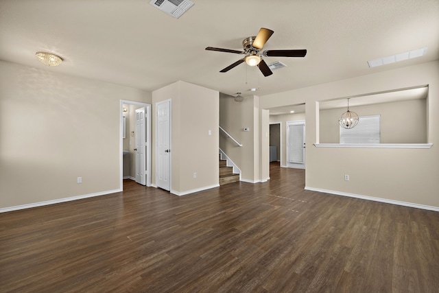 unfurnished living room with ceiling fan with notable chandelier and dark hardwood / wood-style floors