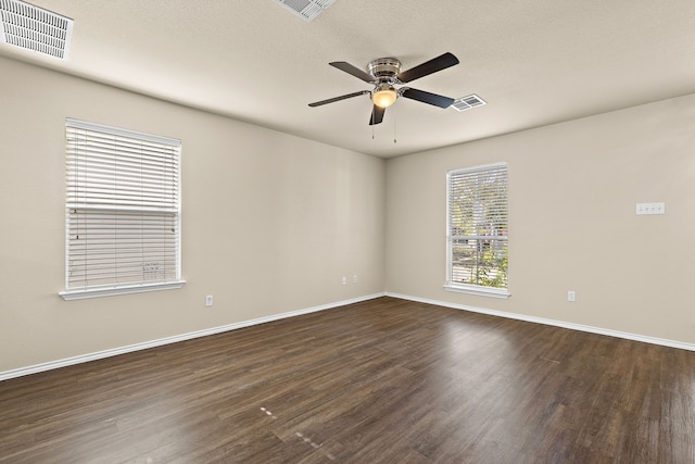 empty room featuring ceiling fan and dark hardwood / wood-style flooring