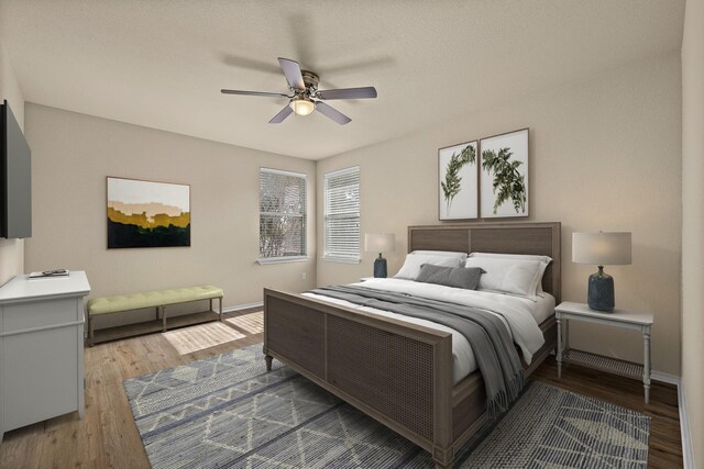 bedroom featuring ceiling fan and hardwood / wood-style flooring