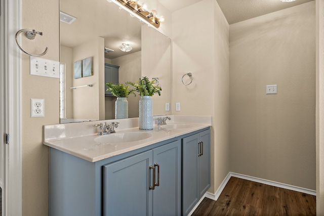 bathroom with hardwood / wood-style floors and vanity