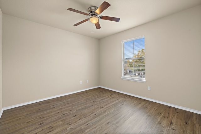 empty room featuring dark wood-type flooring and ceiling fan