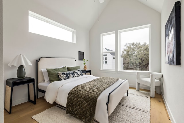 bedroom featuring lofted ceiling and light hardwood / wood-style flooring