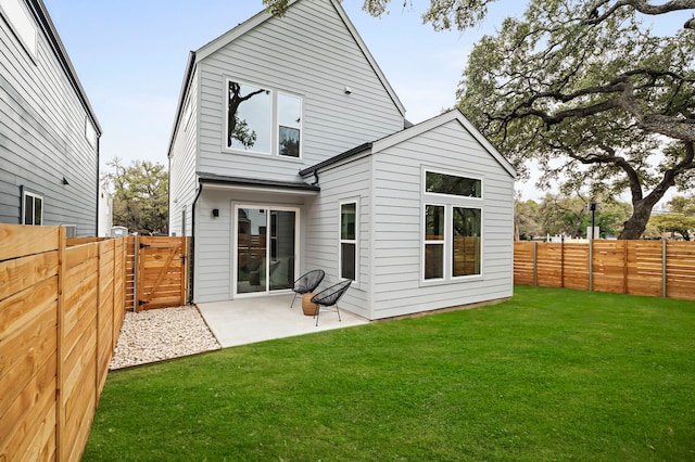 back of property with a lawn and a patio