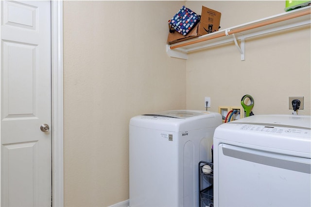 clothes washing area with separate washer and dryer