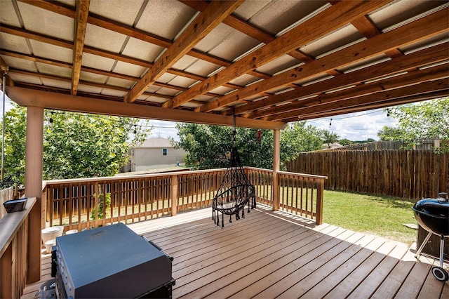 deck featuring grilling area and a lawn