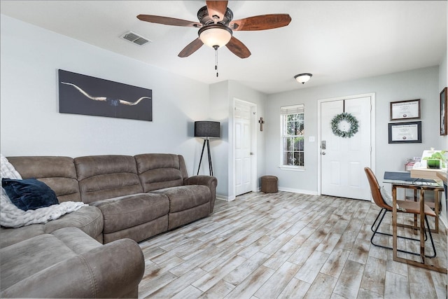 living room with ceiling fan and light hardwood / wood-style floors