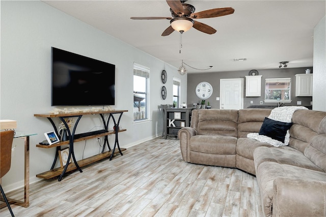 living room with ceiling fan and light wood-type flooring