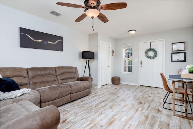 living room with ceiling fan and light hardwood / wood-style flooring