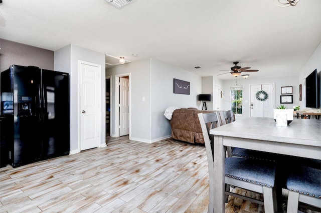 dining room with ceiling fan and light hardwood / wood-style flooring