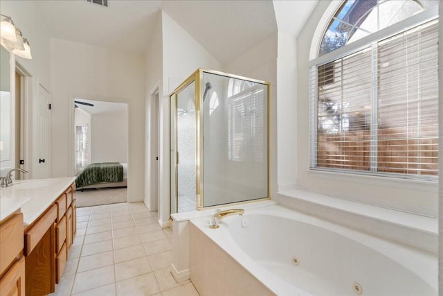 bathroom featuring vanity, vaulted ceiling, tile patterned floors, and shower with separate bathtub