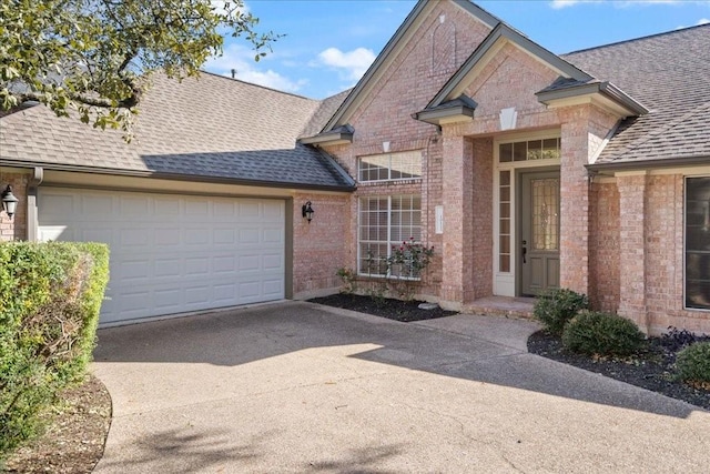 10113 Planters Woods Dr, Austin, TX 78730 - view of front of home with a shingled roof, brick siding, driveway, and a garage