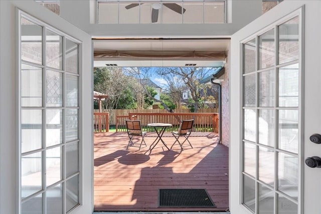 doorway to outside with ceiling fan