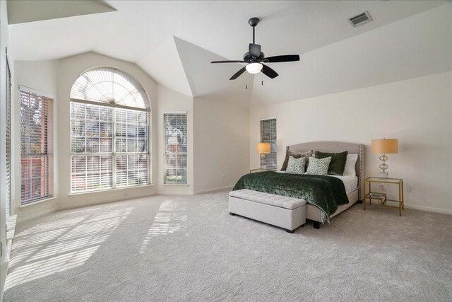 bedroom with ceiling fan, vaulted ceiling, and light carpet