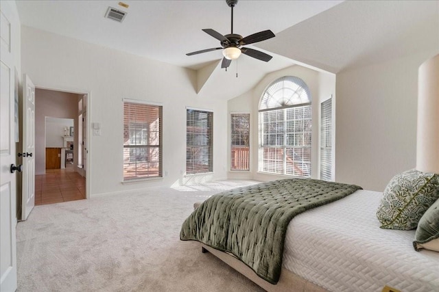 carpeted bedroom with ceiling fan, lofted ceiling, and visible vents