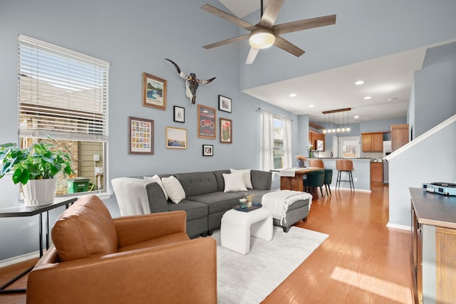 living room featuring ceiling fan and light wood-type flooring