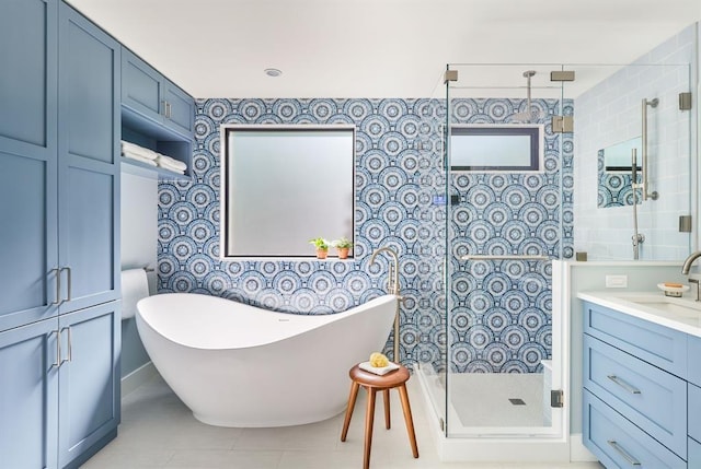 bathroom featuring vanity, independent shower and bath, and tile patterned flooring