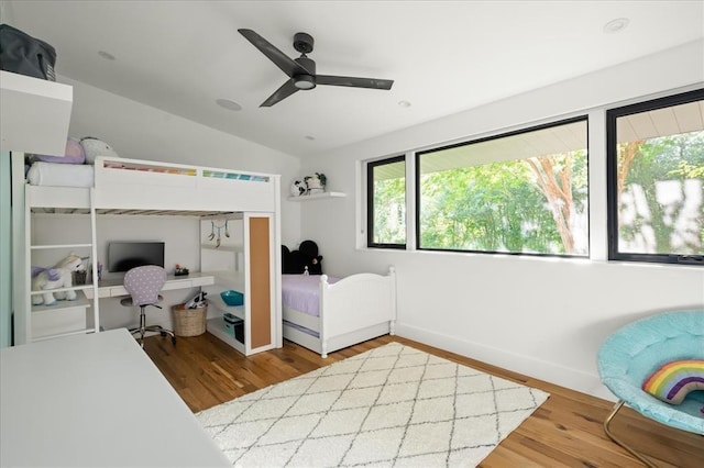 bedroom featuring ceiling fan, wood-type flooring, and lofted ceiling