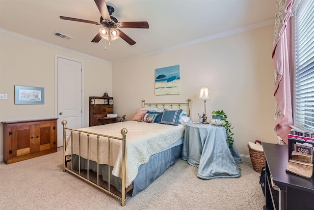 carpeted bedroom featuring ceiling fan and crown molding