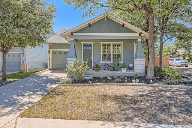 craftsman house featuring covered porch and a garage