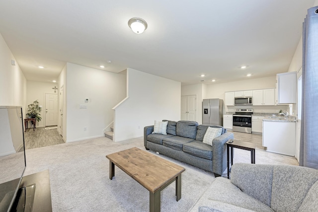 living room featuring light colored carpet and sink